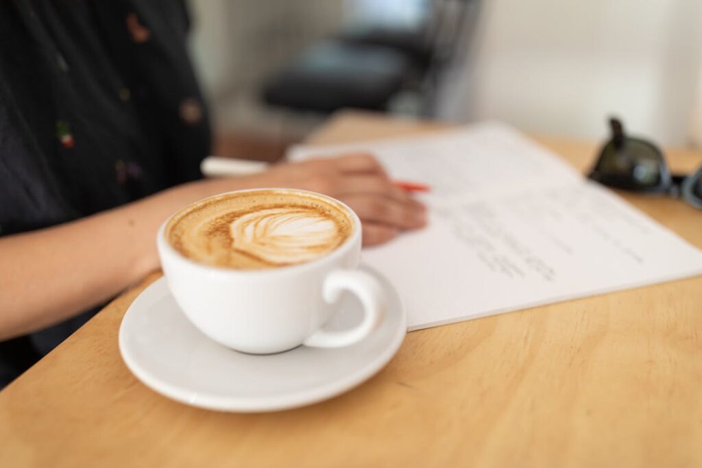 woman-working-with-a-cup-of-coffee-on-the-table